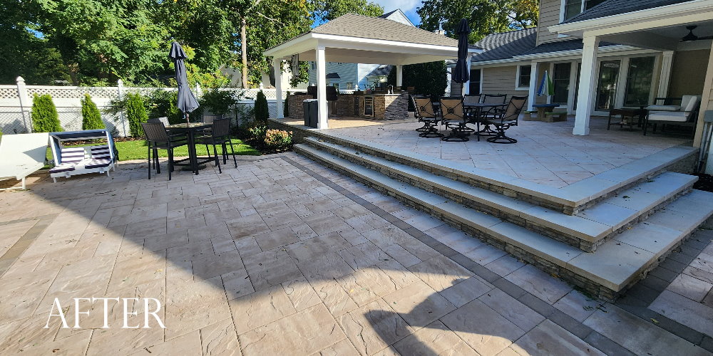 raised patio with outdoor bbq/bar island and pavilion. cambridge XL pavers