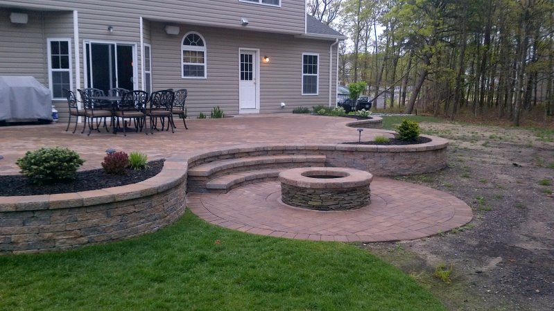 backyard raised patio with fire pit