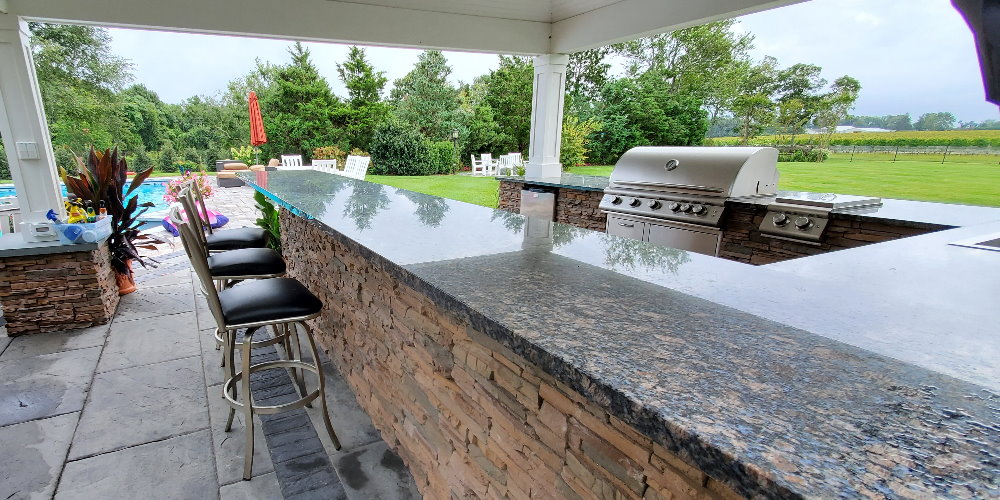 outdoor kitchen with granite counter top bar island