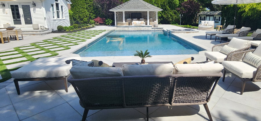 pool with diamond shape pavers and artificial turf